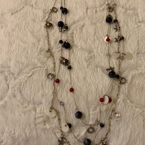 Silver,red and dark grey beads,small white circle .